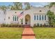 Charming stucco home with a beautiful brick walkway, arched entryway, and an American flag waving proudly at 3512 W Santiago St, Tampa, FL 33629