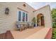 Inviting front porch with Adirondack chairs, plants, and textured stucco exterior at 3512 W Santiago St, Tampa, FL 33629
