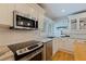 Bright kitchen with white cabinets, stainless steel appliances, and marble countertops at 3512 W Santiago St, Tampa, FL 33629