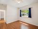 Bedroom featuring wood laminate flooring, ceiling fan and window overlooking exterior at 4301 Ridgemoor N Dr, Palm Harbor, FL 34685