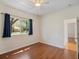 Bedroom with wood laminate flooring, ceiling fan, and window with a view of the exterior at 4301 Ridgemoor N Dr, Palm Harbor, FL 34685
