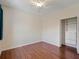 Bedroom featuring ceiling fan, wood laminate flooring and closet with built-in drawers and shelving at 4301 Ridgemoor N Dr, Palm Harbor, FL 34685