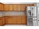 Kitchen features stainless steel refrigerator, granite countertops, and ample cabinet space at 4301 Ridgemoor N Dr, Palm Harbor, FL 34685