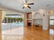 This living room features hardwood floors, a fireplace and a great view of the pool at 4301 Ridgemoor N Dr, Palm Harbor, FL 34685
