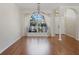 Spacious living room with large windows, laminate floors, and an elegant chandelier at 4301 Ridgemoor N Dr, Palm Harbor, FL 34685