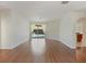 Open-concept living room with laminate flooring and sliding glass doors leading to the pool at 4301 Ridgemoor N Dr, Palm Harbor, FL 34685