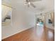 Spacious living room with hardwood floors, ceiling fan, and sliding glass doors to the pool area at 4301 Ridgemoor N Dr, Palm Harbor, FL 34685