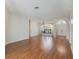 Bright living room featuring laminate flooring, large windows, and an arched doorway at 4301 Ridgemoor N Dr, Palm Harbor, FL 34685