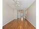 An open floor plan featuring a living room with hardwood flooring, ceiling fans, and a view to the bathroom at 4301 Ridgemoor N Dr, Palm Harbor, FL 34685