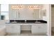 Elegant main bathroom featuring dual sinks, granite countertops, tile floors, and ample storage at 4301 Ridgemoor N Dr, Palm Harbor, FL 34685