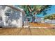 Backyard view showcases the wooden deck, mature tree, and well-maintained exterior at 4530 5Th S Ave, St Petersburg, FL 33711