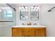Dual vanity bathroom features modern lighting, marble countertop, and glass enclosed shower at 4530 5Th S Ave, St Petersburg, FL 33711