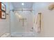 Bright bathroom with white tiled shower, glass door, and decorative art at 4530 5Th S Ave, St Petersburg, FL 33711