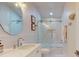 Bright bathroom featuring a white vanity, modern fixtures, and tub with glass doors at 4530 5Th S Ave, St Petersburg, FL 33711
