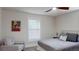 Bedroom featuring neutral walls, ceiling fan, a cozy chair, and bright window at 4530 5Th S Ave, St Petersburg, FL 33711
