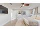 Spacious bedroom with ceiling fan, wall art, and a door leading to a private area at 4530 5Th S Ave, St Petersburg, FL 33711