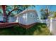 Back exterior features wood deck, new vinyl siding, and manicured lawn at 4530 5Th S Ave, St Petersburg, FL 33711
