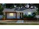 Charming single-story home with a modern black door and inviting wooden porch at 4530 5Th S Ave, St Petersburg, FL 33711