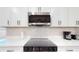 Modern kitchen boasting stainless steel appliances, white cabinets, and ample counter space at 4530 5Th S Ave, St Petersburg, FL 33711