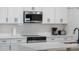 Kitchen featuring stainless steel microwave and oven surrounded by white cabinets and counters at 4530 5Th S Ave, St Petersburg, FL 33711