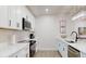 Bright, modern kitchen with stainless steel appliances, white cabinetry, and ample counter space at 4530 5Th S Ave, St Petersburg, FL 33711