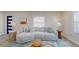 Bright living room featuring a comfortable sofa, stylish decor, and large windows at 4530 5Th S Ave, St Petersburg, FL 33711