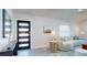 Bright living room featuring a modern sofa, stylish decor, and a contemporary front door at 4530 5Th S Ave, St Petersburg, FL 33711