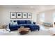 Living room with a blue sectional sofa, decorative artwork, and ample natural light at 4530 5Th S Ave, St Petersburg, FL 33711