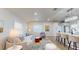 Open concept living room with a stylish sofa, modern decor, and an island with bar stools at 4530 5Th S Ave, St Petersburg, FL 33711