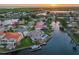 Panoramic aerial view of waterfront homes at sunset with private docks and beautiful water views at 4803 Longwater Way, Tampa, FL 33615