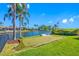 Backyard putting green surrounded by landscaping overlooking the water at 4803 Longwater Way, Tampa, FL 33615