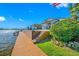 Waterfront backyard featuring a dock, multi-level patio, and lush landscaping, perfect for enjoying the outdoors at 4803 Longwater Way, Tampa, FL 33615