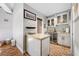 Modern bar area features granite countertops, beverage cooler, and white cabinetry at 4803 Longwater Way, Tampa, FL 33615