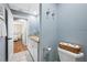 Charming blue bathroom features granite counters, white cabinets and opens to bedroom with wood floors at 4803 Longwater Way, Tampa, FL 33615