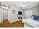Bright bedroom with ceiling fan, wood floors, and a colorful painting of an elephant on the wall at 4803 Longwater Way, Tampa, FL 33615