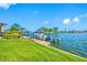 Private boat dock with boat lift, bordered by a manicured green lawn at 4803 Longwater Way, Tampa, FL 33615