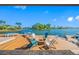 Waterfront dock with outdoor seating and a fire pit perfect for relaxing by the water at 4803 Longwater Way, Tampa, FL 33615