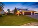 Stately home with lush landscaping, paver driveway, three-car garage, and inviting front entrance at 4803 Longwater Way, Tampa, FL 33615