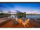 Inviting fire pit area on a dock overlooking a tranquil waterway with lounge seating at 4803 Longwater Way, Tampa, FL 33615