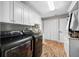 Laundry room with brick floors and plenty of storage space and laundry sink at 4803 Longwater Way, Tampa, FL 33615
