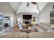 Spacious living room features a modern fireplace, vaulted ceiling, and lake views at 4803 Longwater Way, Tampa, FL 33615