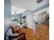 Inviting living room with wood floors, vaulted ceilings, and serene waterfront views at 4803 Longwater Way, Tampa, FL 33615