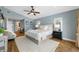 Cozy main bedroom with a king bed, soft rug, ceiling fan, and en-suite bathroom at 4803 Longwater Way, Tampa, FL 33615