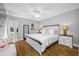 Relaxing main bedroom featuring a king bed, ceiling fan, and a large window at 4803 Longwater Way, Tampa, FL 33615