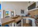 Outdoor kitchen with BBQ, sink, stainless steel refrigerator and outdoor television for entertaining at 4803 Longwater Way, Tampa, FL 33615