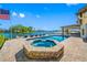 Gorgeous backyard featuring a pool, spa, and waterfront views perfect for outdoor entertaining at 4803 Longwater Way, Tampa, FL 33615