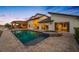 Backyard oasis with a pool, hot tub, covered patio, and captivating views of the waterfront at 4803 Longwater Way, Tampa, FL 33615