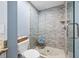 Walk-in shower showcasing glass enclosure and tiled walls, paired with neutral toilet area at 4803 Longwater Way, Tampa, FL 33615