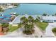 An aerial view of a home with a metal roof surrounded by lush, tropical trees at 512 173Rd E Ave, North Redington Beach, FL 33708
