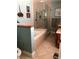 Bathroom featuring a separate shower, a jetted tub, vanity with cabinet, tile floors, and neutral colored walls at 512 173Rd E Ave, North Redington Beach, FL 33708